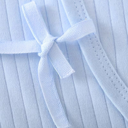 Sky Blue - Close-up of a light blue martial arts uniform with a belt.