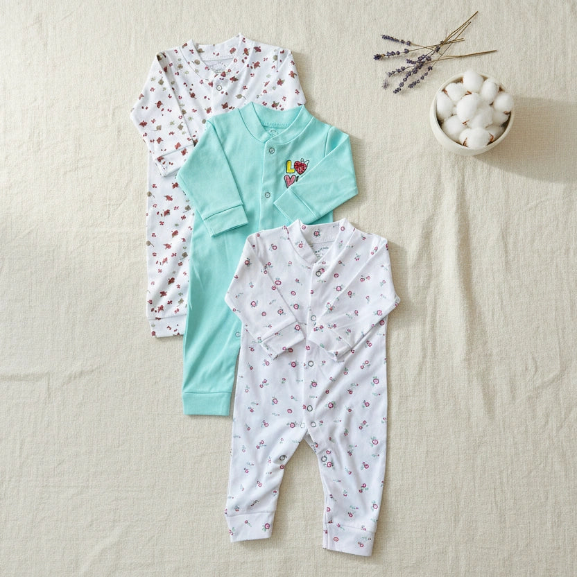 Three baby rompers with floral patterns on a white background