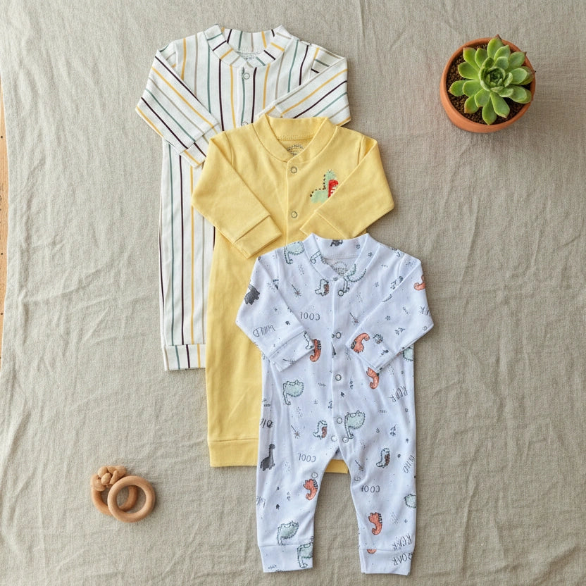 Three baby outfits including a striped shirt, yellow polo shirt, and patterned onesie on a white background.