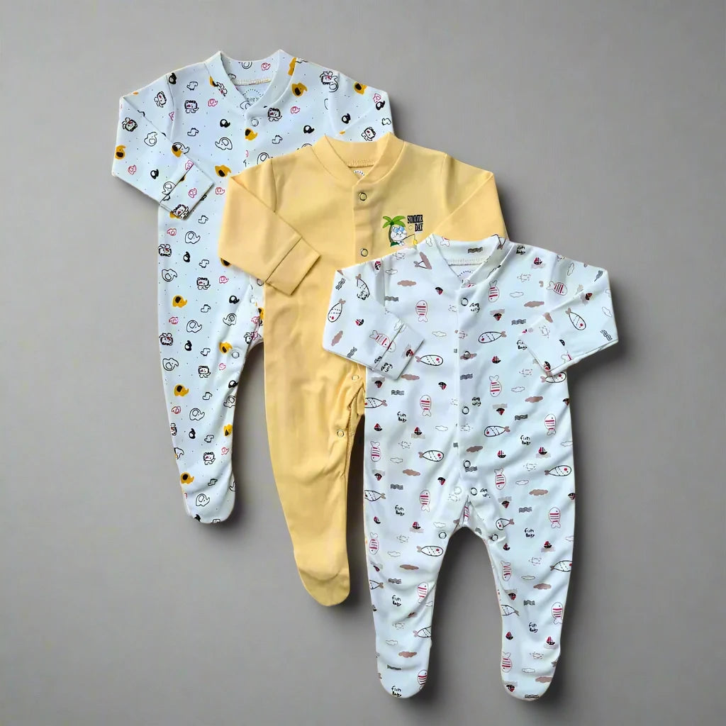 Three baby rompers from Carter's are arranged vertically. The first romper features small car and animal patterns on a white background, complete with convenient snap-button closures. The second romper is solid yellow with a small print on the chest, while the third showcases small fish designs on a light blue background in ultra-soft cotton. This set is part of Carter's Pack Of 3 Baby Girl/Boy Footed Rompers (Yellow-Themed).