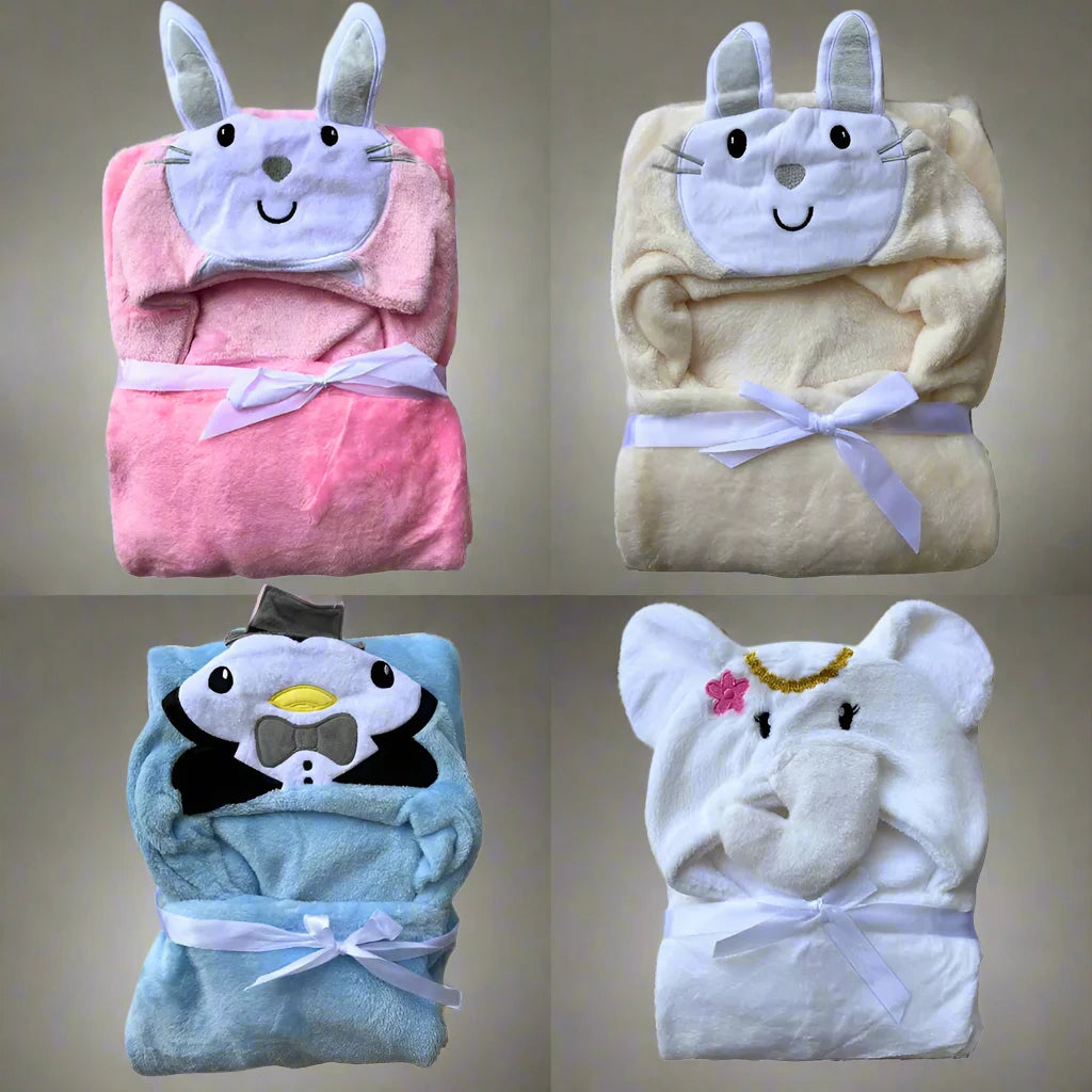 Introducing the Alaya Junior Character Hooded Blanket/Wrapping Sheet – Winter (100 x 70 cm) set, featuring four ultra-soft baby blankets with adorable character hood designs: a pink bunny face blanket, a cream bear face blanket, a blue penguin face blanket, and a white elephant face blanket adorned with a flower and beaded necklace.