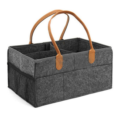Gray storage caddy with brown leather handles on a white background