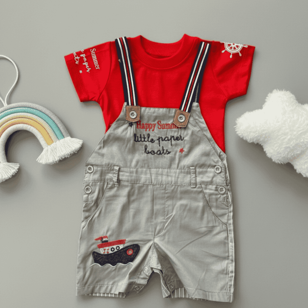 Children's outfit with red shirt and gray overalls on a gray background