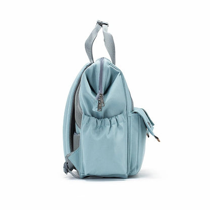 The Ellie & Luke Multifunctional Diaper Bag (Blue) is shown from the side with a top handle, two adjustable shoulder straps, a front zipper pocket, and elastic side pockets for bottles or small items, making it ideal as a unisex diaper bag.