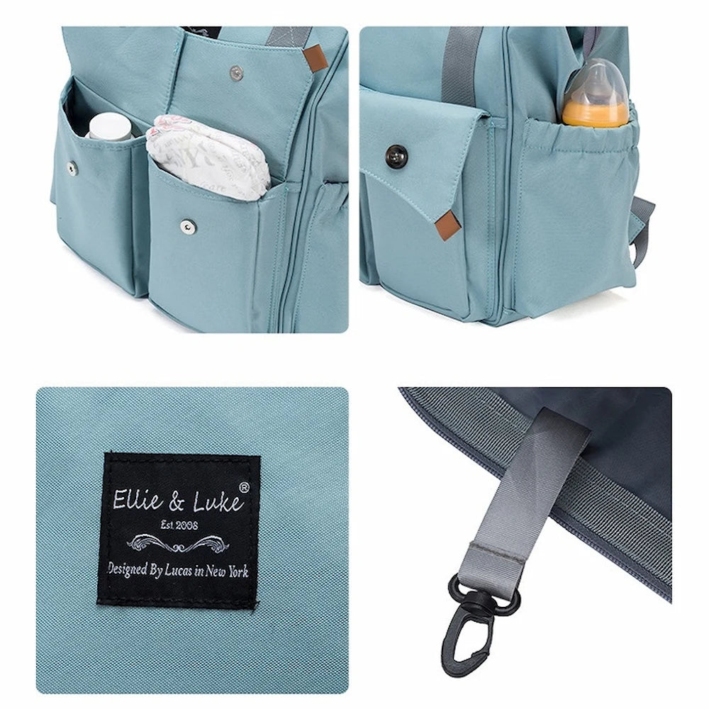 A light blue, unisex Ellie & Luke Multifunctional Diaper Bag (blue) with multiple pockets holds a bottle and baby wipes. A close-up of the label reads "Ellie And Luke, Est 2005, Designed by Lucas in New York." A strap with a hook is also visible.