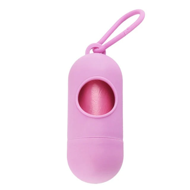 The Alaya Junior Diaper Waste Bags include 4 rolls of disposable pink bags in a capsule-shaped dispenser with a window. Made from biodegradable plastic, this pink container has a loop for easy attachment to bags or belts, ideal for diaper waste.