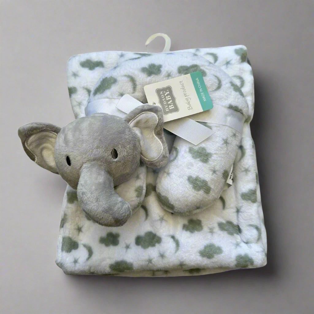 Plush elephant toy and blanket with a tag on a white background