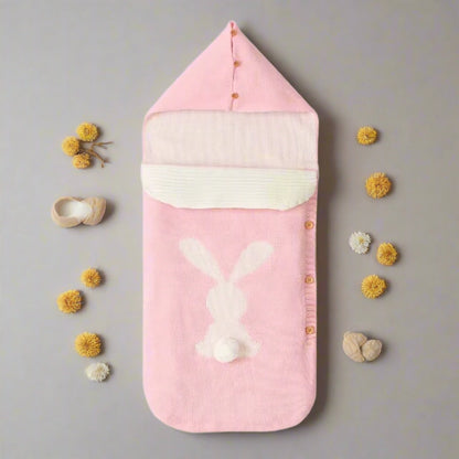 Pink baby swaddle with bunny design on a white background