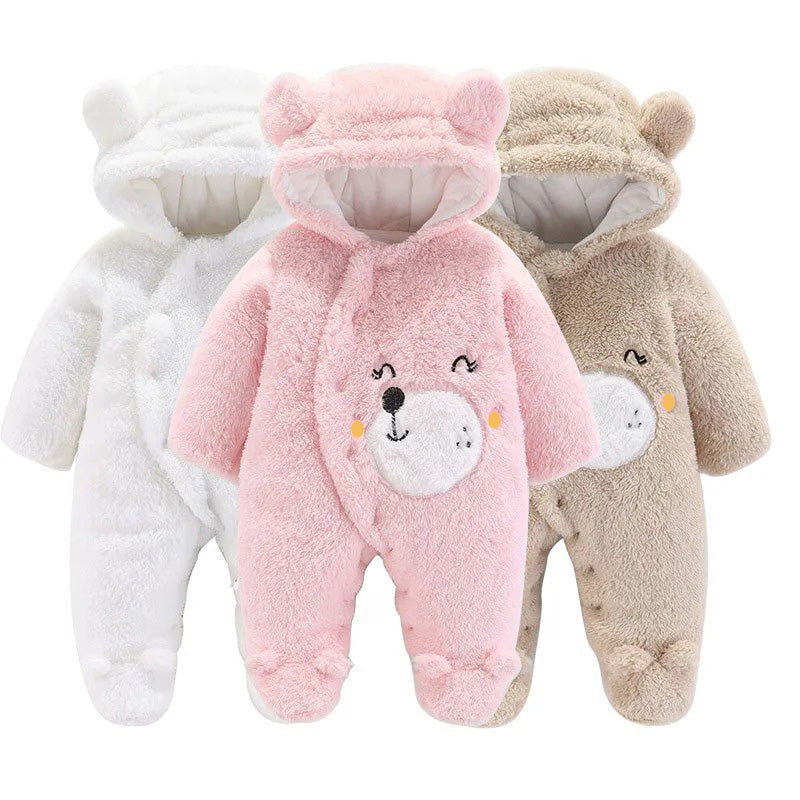 Displayed are three cozy Snuggly Bear Hug rompers from Alaya Junior. Each plush fabric baby outfit features bear ears on the hood and an embroidered bear face on the front. The available colors are white, pink, and beige. These onesies have long sleeves and covered feet, making them perfect winter baby clothing for added warmth.