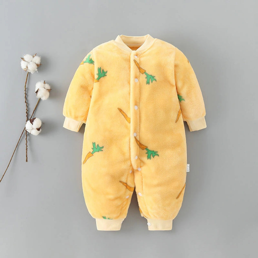 Yellow baby onesie with carrot design on a gray background