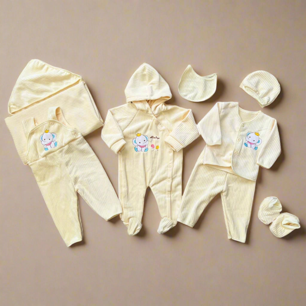 Baby clothing set with hoodies, pants, and hats on a beige background