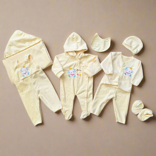 Baby clothing set with hoodies, pants, and hats on a beige background