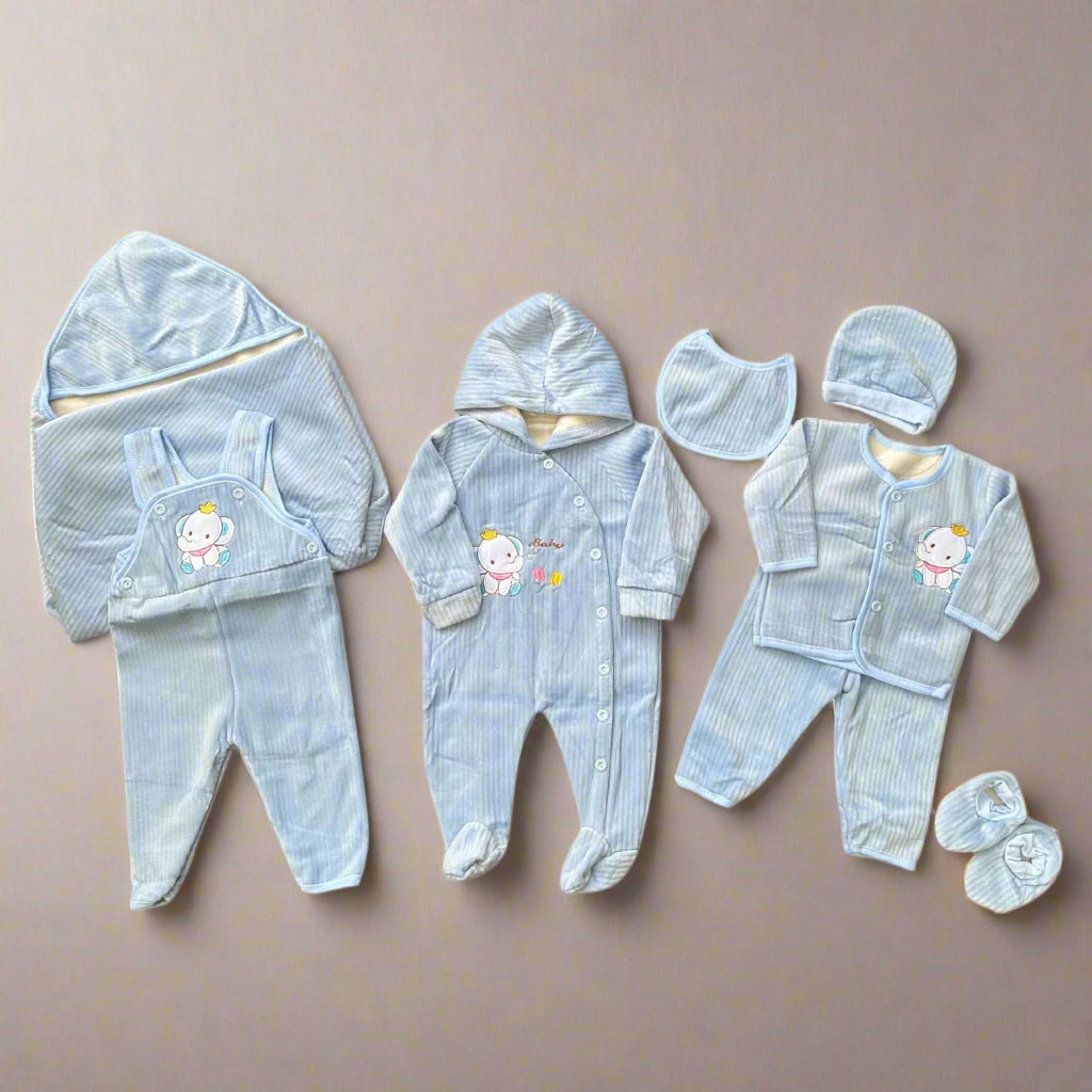Collection of baby blue outfits with cartoon characters on a beige background