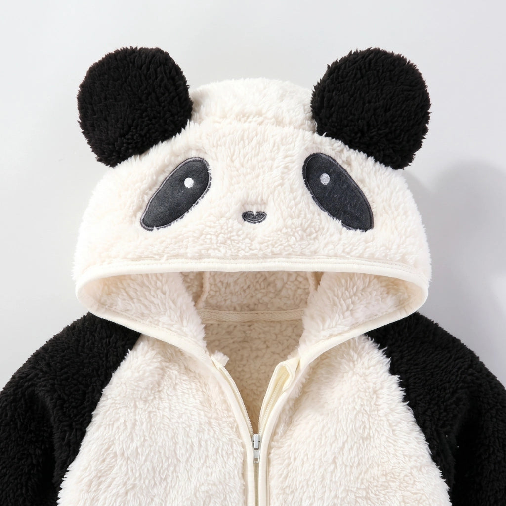 A close-up of a plush panda-themed hooded zip-up jacket. The garment features a soft cream fleece face on the hood with black embroidered eyes, nose, and ear patches, plus black plush ears and black sleeves, set against a plain light gray background.