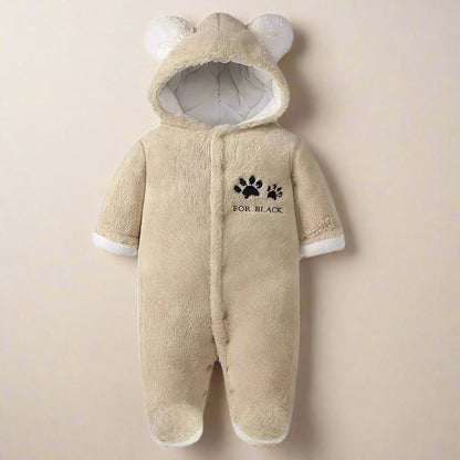 Beige baby romper with bear ears and paw print design on a white background