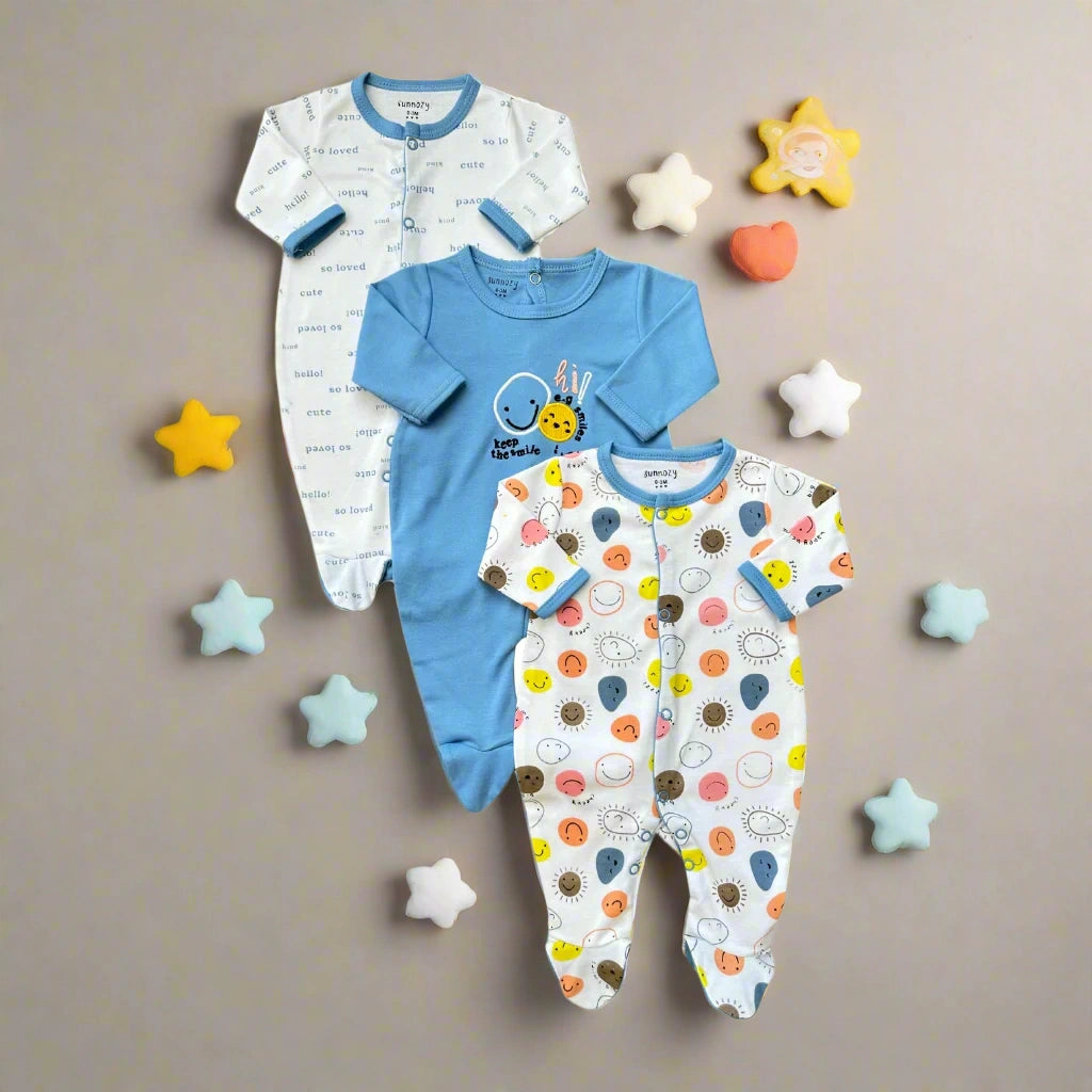 Three baby onesies with different patterns on a white background