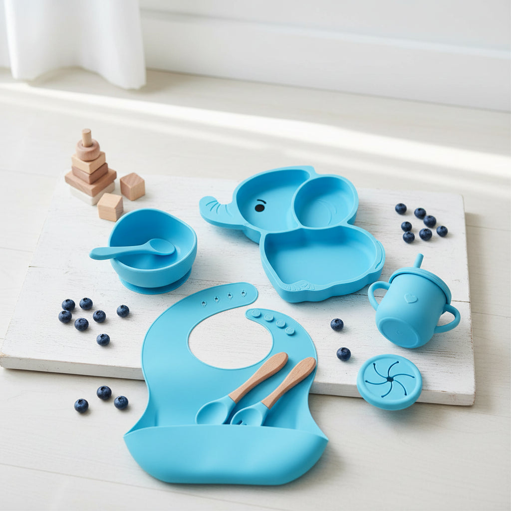 Blue elephant-shaped children's tableware set on a white background