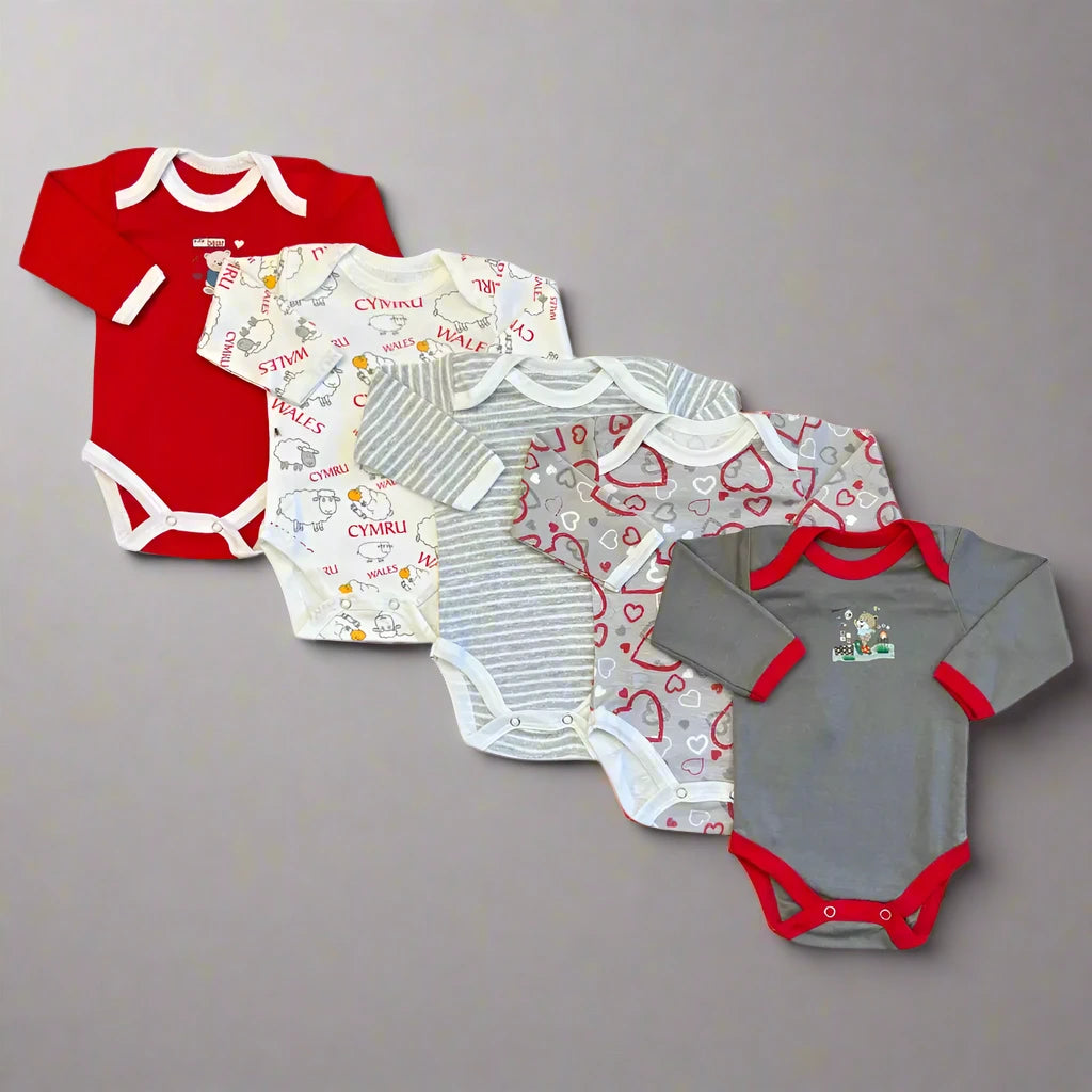 Carter’s Unisex Baby Full Sleeves Bodysuits Pack of 5 – Red-Themed features five durable, machine-washable bodysuits arranged in a gradient from red to gray. From left to right, the designs include solid red, white with red and multicolored prints, gray with stripes, gray with heart prints, and solid gray with red trim accompanied by a small chest design. These bold and gender-neutral designs are perfect for any baby.