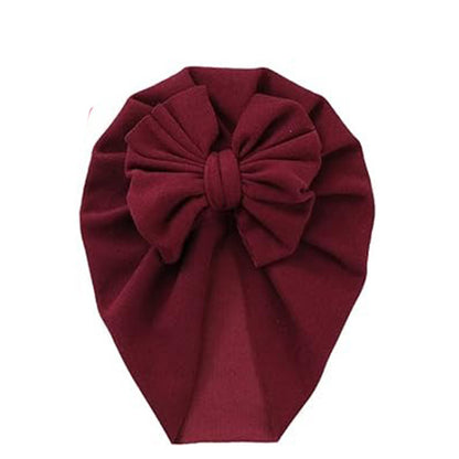 The PatPat Baby / Toddler Solid Bowknot Hat by Alaya Junior is perfect for your little one, featuring a large, gathered bow and intricate pleated detailing. This maroon fabric turban is a chic choice for any occasion.