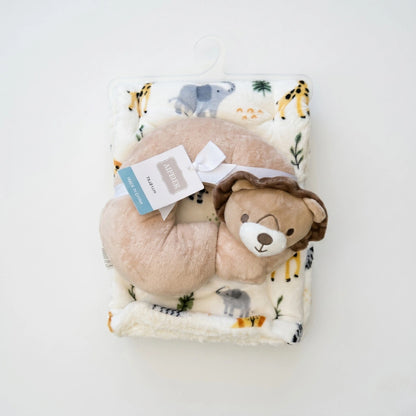 Plush toy bear on a blanket with animal prints on a white background