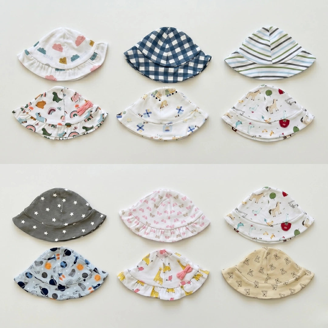 Collection of colorful children's bucket hats on a light background
