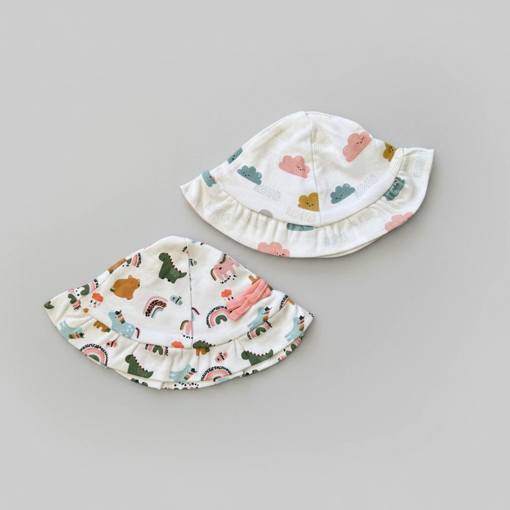 Two children's sun hats with colorful patterns on a gray background