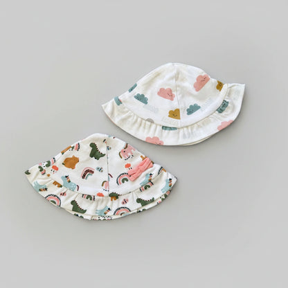 Two children's sun hats with colorful patterns on a gray background