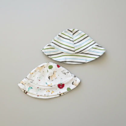 Two baby hats on a gray background, one with animal prints and the other with stripes.