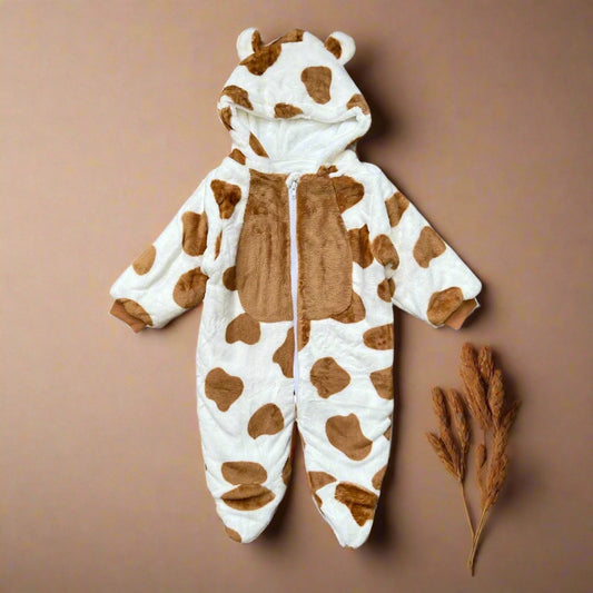 Children's onesie with cow pattern on a white background