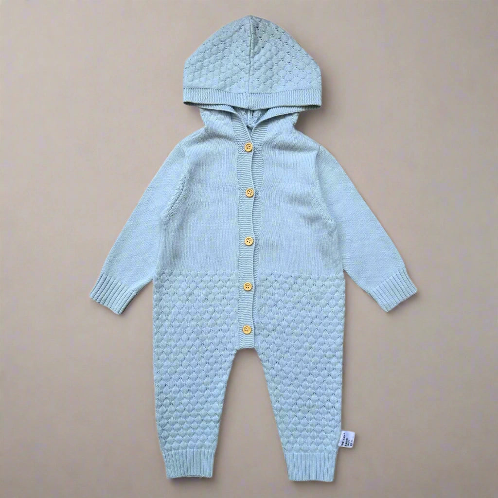 Light blue knitted baby romper with a hood on a white background