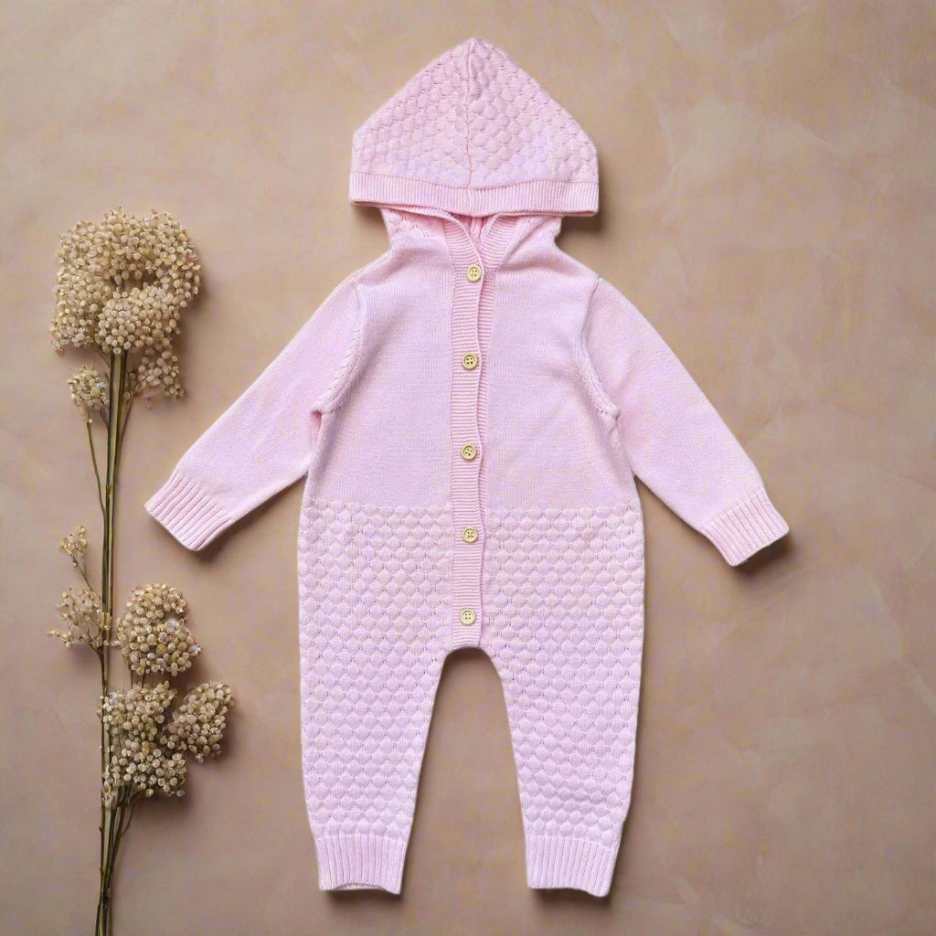 Pink baby onesie with a hood on a white background