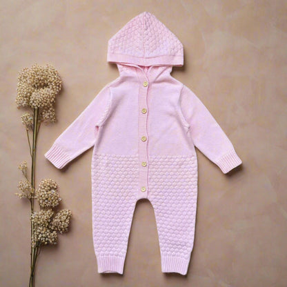 Pink baby onesie with a hood on a white background