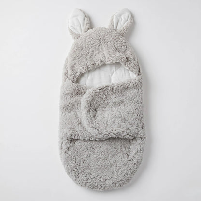 A light gray plush baby bootie with bunny ears on the hood, shown flat against a clean white background.