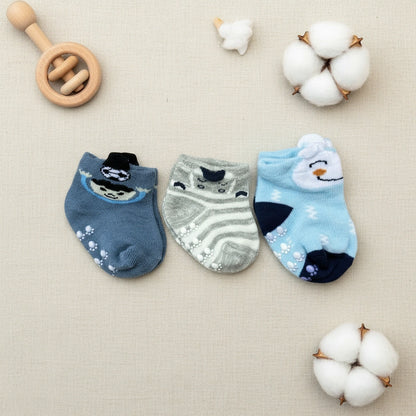 Three pairs of baby socks with animal designs on a white background
