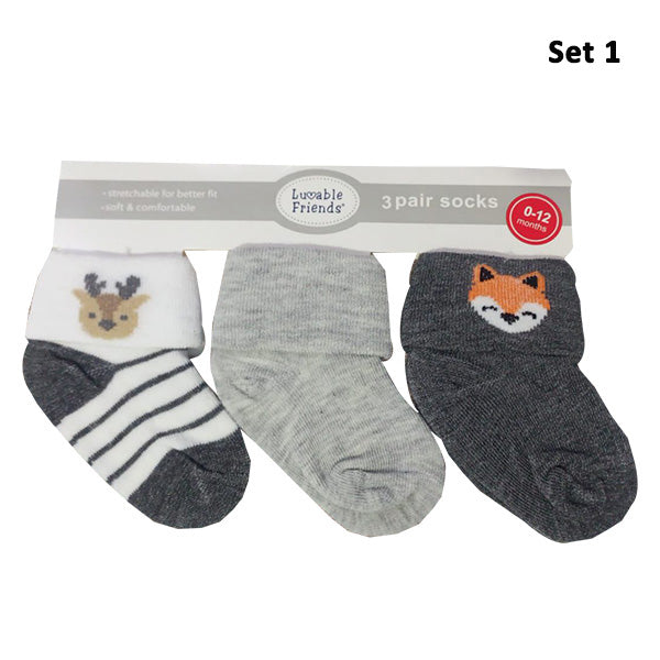 The Luvable Baby 3-Pair Socks Gift Set by Hudson features three pairs of baby socks with cuffs, perfect for ages 0-12 months. Crafted from soft and stretchy fabric to ensure they stay on, the first pair showcases a delightful deer face with black stripes on a white background. The second pair is a solid gray, while the third highlights an adorable orange fox face on dark gray.