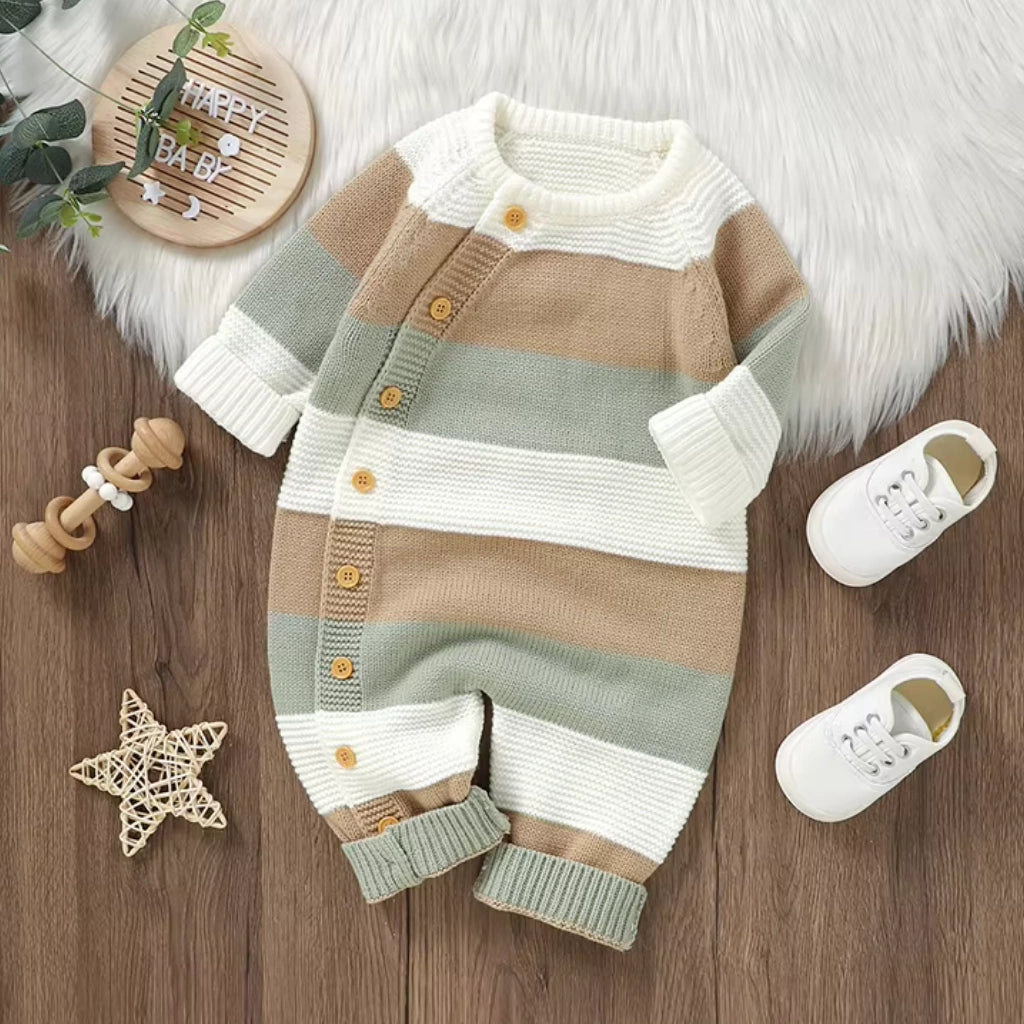 White - Baby outfit with striped sweater and pants on a wooden surface with shoes and a star decoration.