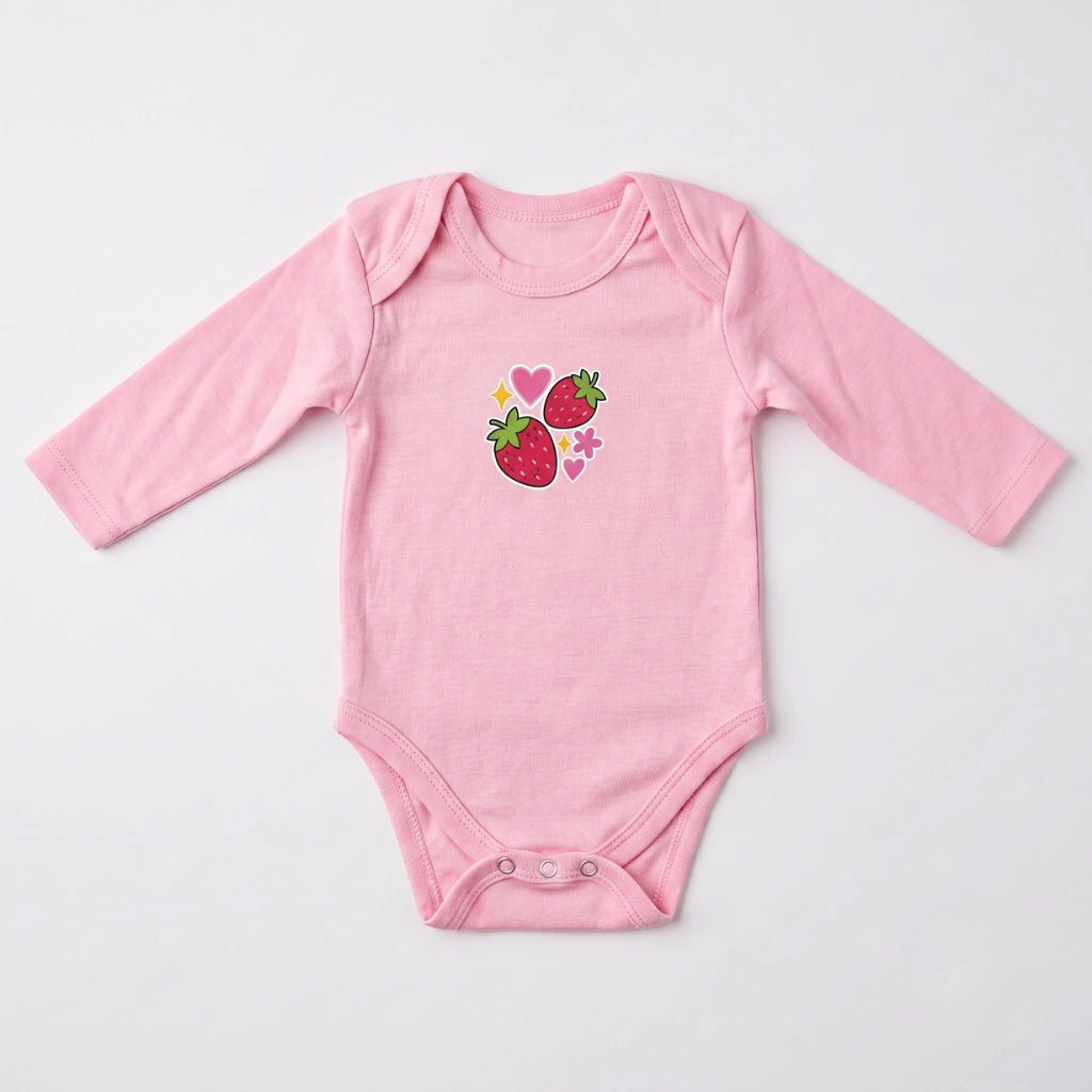 A light pink long-sleeve baby bodysuit with a graphic of two strawberries and small hearts on the chest, laid flat on a light gray background.