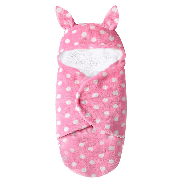 Introducing the Pink Snuggle ultra-soft fleece sleeping bag/swaddle for newborns by Alaya Junior. This adorable baby essential features a charming design with white polka dots and two small ear-like protrusions at the top, perfect for swaddling your little one in comfort.