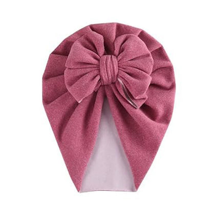 The Alaya Junior PatPat Baby / Toddler Solid Bowknot Hat is a delightful pink velvet turban adorned with a large decorative bow, perfect for stylish little ones.