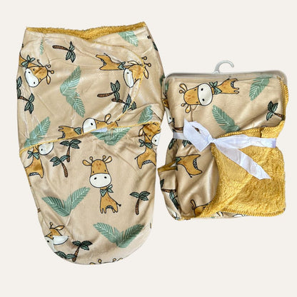 Two baby blankets from Alaya Junior's "Cuddly Duo: Baby Winter Blanket with Swaddle - Adorable Designs" collection are shown. One is unwrapped, displaying a beige fabric with cute giraffe and leaf patterns, featuring yellow trim. The other is folded and tied with a white ribbon, with some of its yellow lining visible, on a white hanger—perfect additions to newborn baby clothing collections in Pakistan.