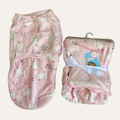 A pair of pink baby winter blankets and swaddles from Alaya Junior's Cuddly Duo: Baby Winter Blanket with Swaddle - Adorable Designs, featuring playful unicorns, rainbows, and hearts. One set is neatly folded and tied with a ribbon, while the other piece is partially folded. Both are crafted from soft, fluffy material.